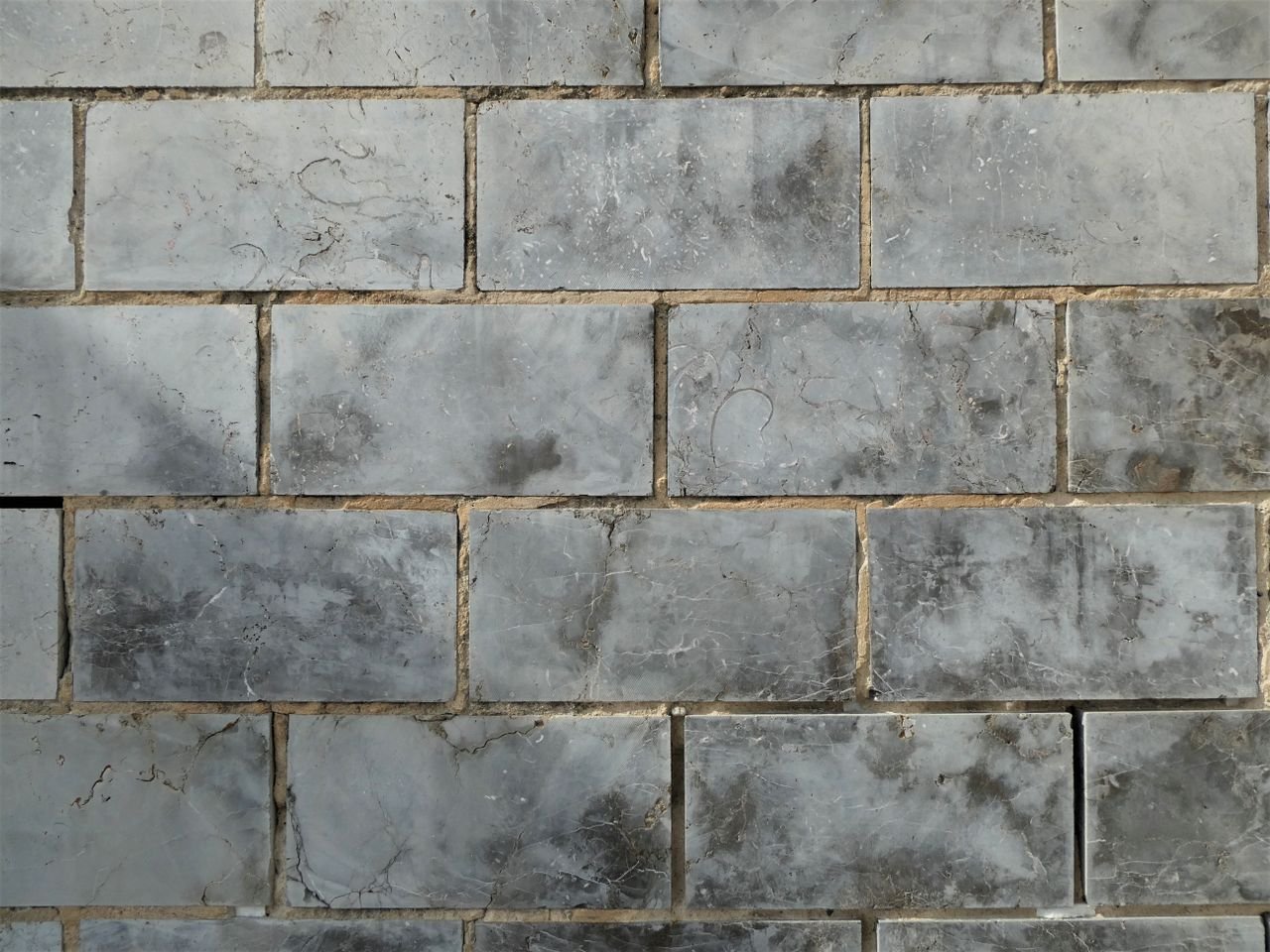 quality-assurance-02 Close-up of textured ceramic wall tiles forming a uniform pattern.